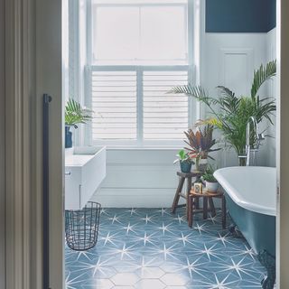 bathroom with potted plant and white bathtub