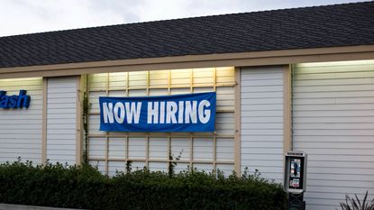 jobs report shows strong hiring; a photo of a now hiring sign