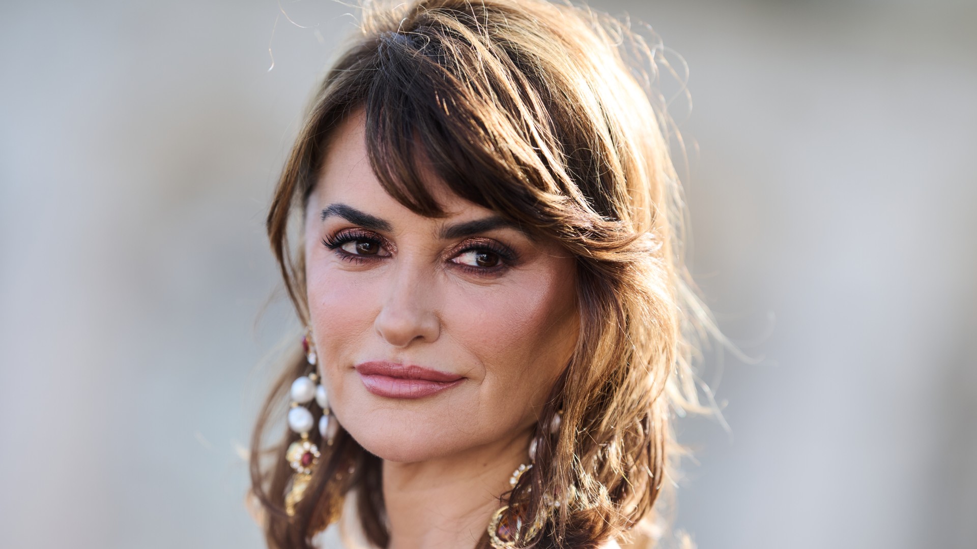 a close up photo of a middle-aged woman with shoulder-length brown hair