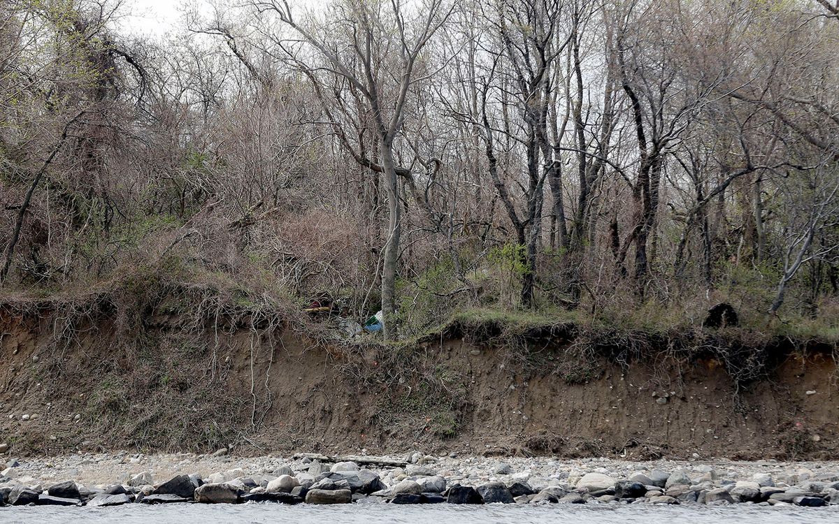 Small flags mark the locations where coastal erosion has revealed human remains on Hart Island in New York. 