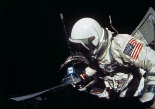 NASA astronaut Buzz Aldrin performs a stand-up EVA (SEVA) as part of the Gemini 12 mission in November 1966.