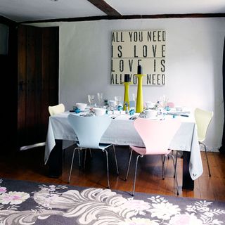 dining room with wooden floor and white wall and white tablecloth and white chair