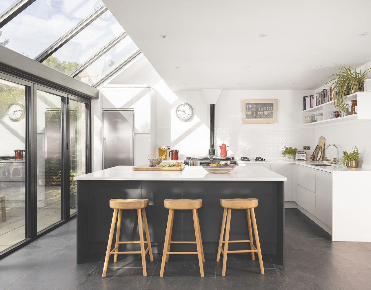 glass extension to modern black and white kitchen