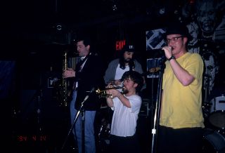 Peter Dinklage playing trumpet with Whizzy at Columbia University, 1994.