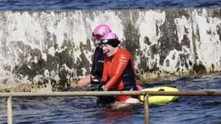 two swimmers finish the kessock swim