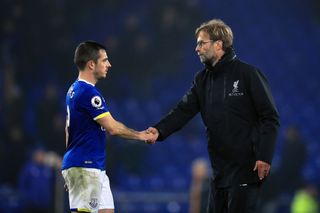 Liverpool manager Jurgen Klopp (right) shakes hands with Everton’s Leighton Baines