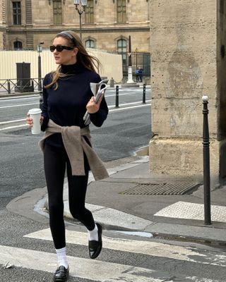 Woman wearing leggings with loafers.