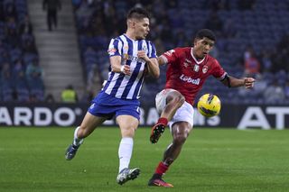 Francisco Moura of Porto competes for the ball with Vinicius Lopes of Santa Clara during a 2025 Primeira Liga match