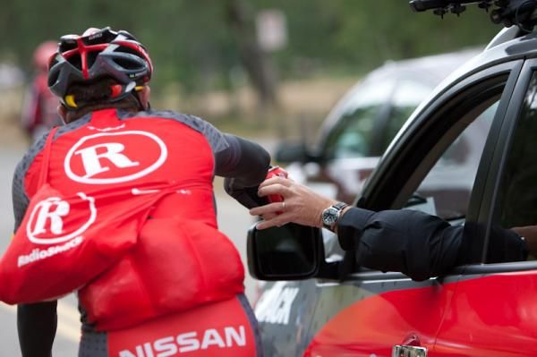 Radioshack now does delivery: a rider collects the food and drinks for his team-mates.