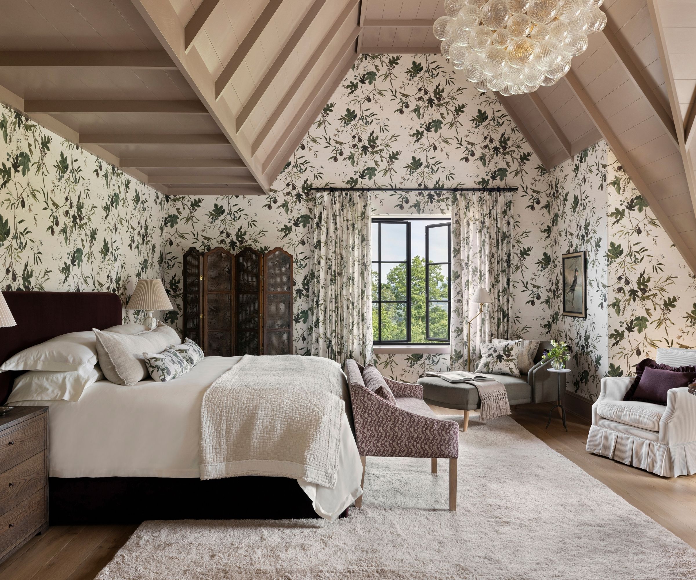 A loft bedroom decorated with green and white floral wallpaper