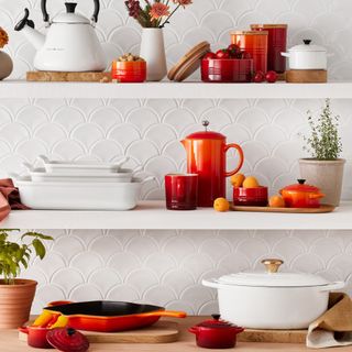 Le Creuset cookware pieces styled on kitchen shelves