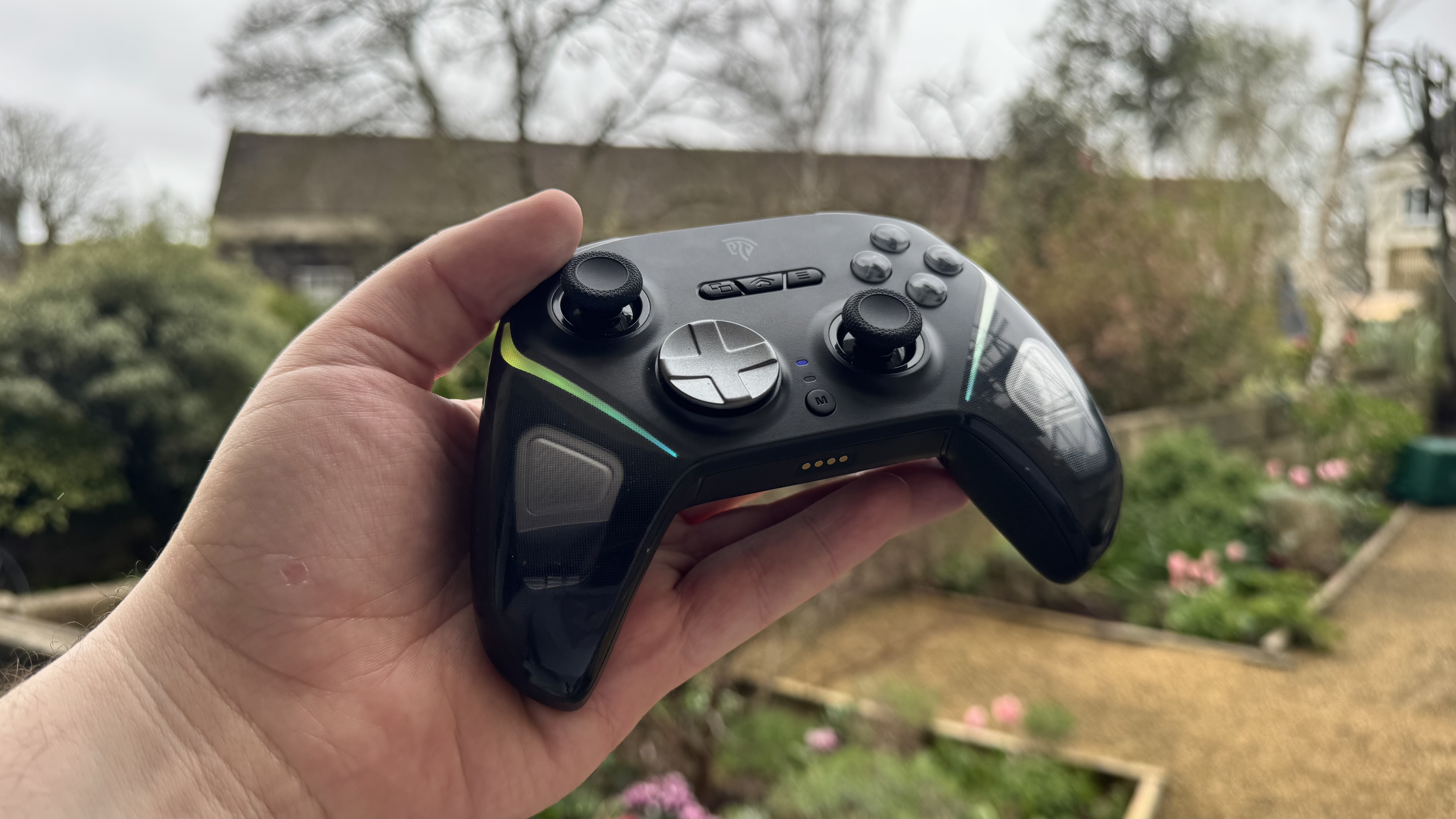 EasySMX D10 (on) in a hand while outside