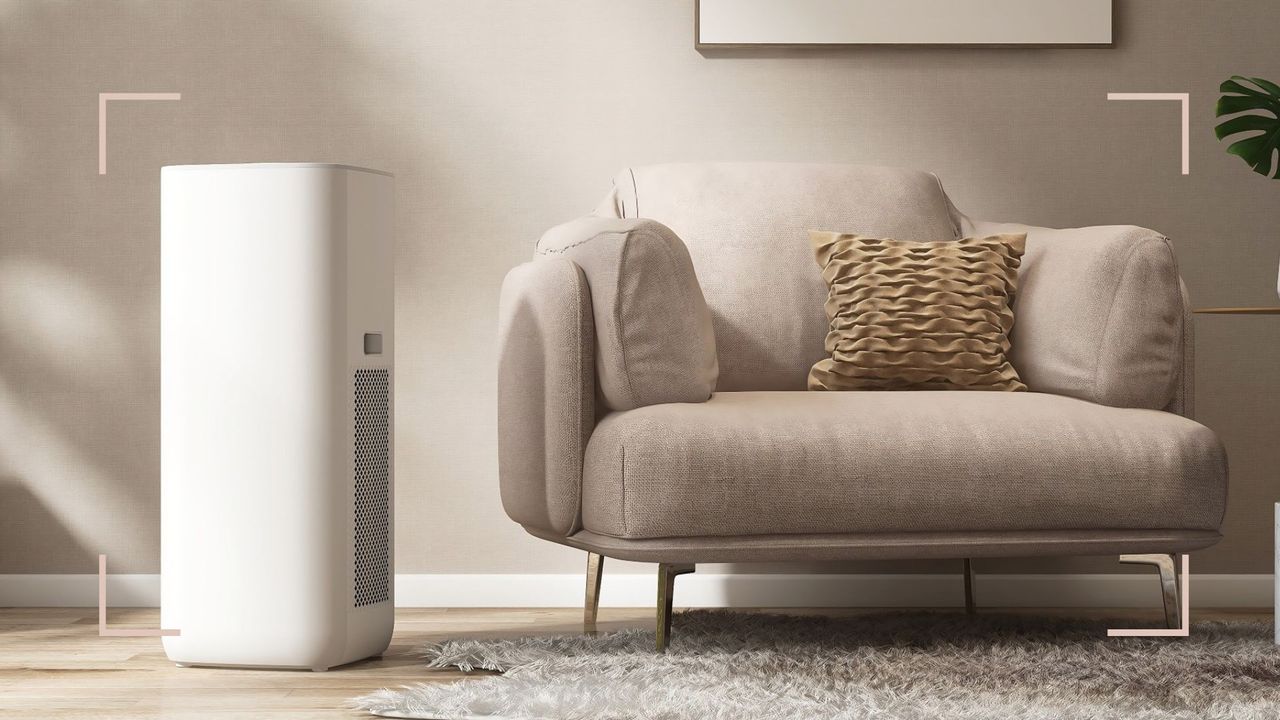 a large dehumidifier next to a beige armchair in a beige living room, to illustrate &#039;what size dehumidifier do I need&#039;