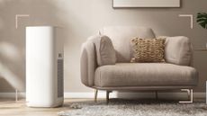 a large dehumidifier next to a beige armchair in a beige living room, to illustrate 'what size dehumidifier do I need'