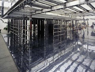 Interior of a metal structure with bars and shiny floor