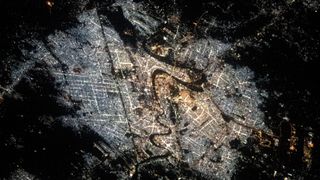 overhead view of baghdad with city lights shining into the sky