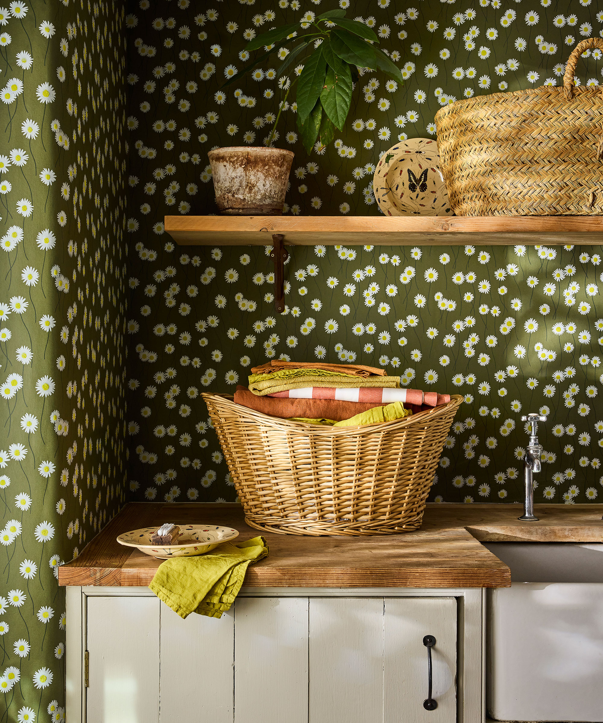 small rustic utility room with green and white daisy patter wallpaper