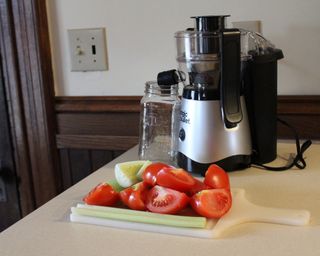 Magic Bullet mini juicer with chopped tomatoes, celery and cucumber
