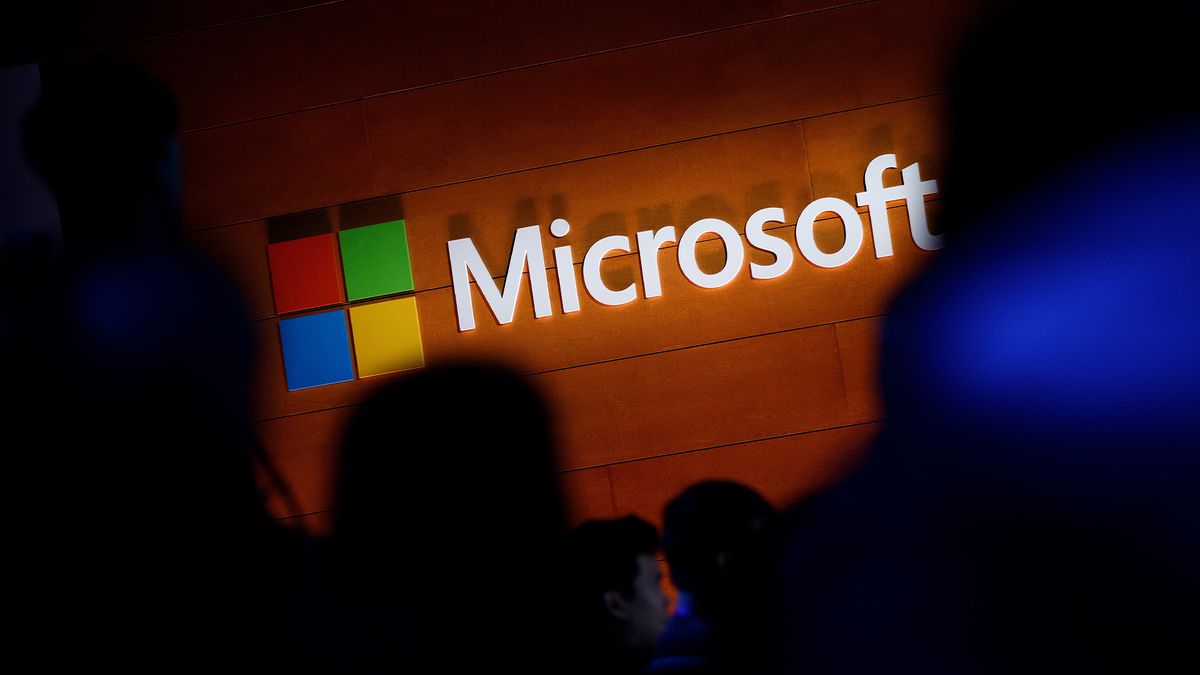 The Microsoft logo is illuminated on a wall during a Microsoft launch event to introduce the new Microsoft Surface laptop and Windows 10 S operating system, May 2, 2017 in New York City