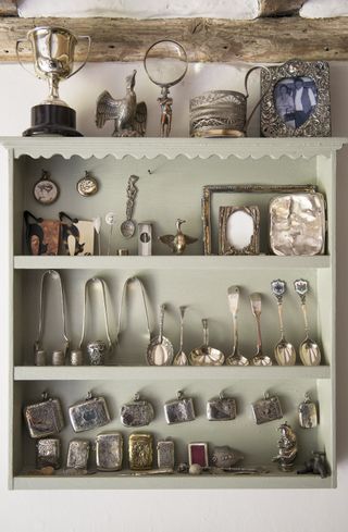 Silverware displayed in an open cabinet