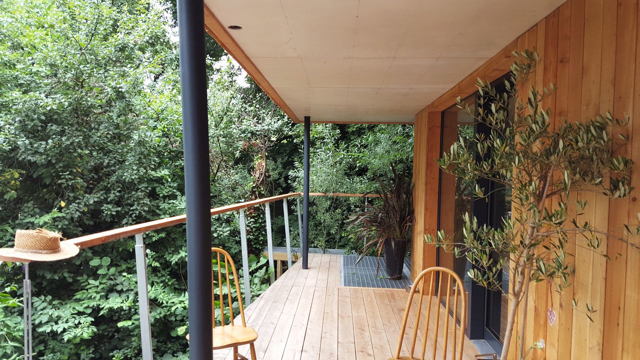 timber clad self build with a balcony
