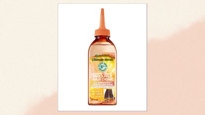 Image of Garnier&#039;s Glowing Lengths Pineapple Hair Drink on a pink and cream background