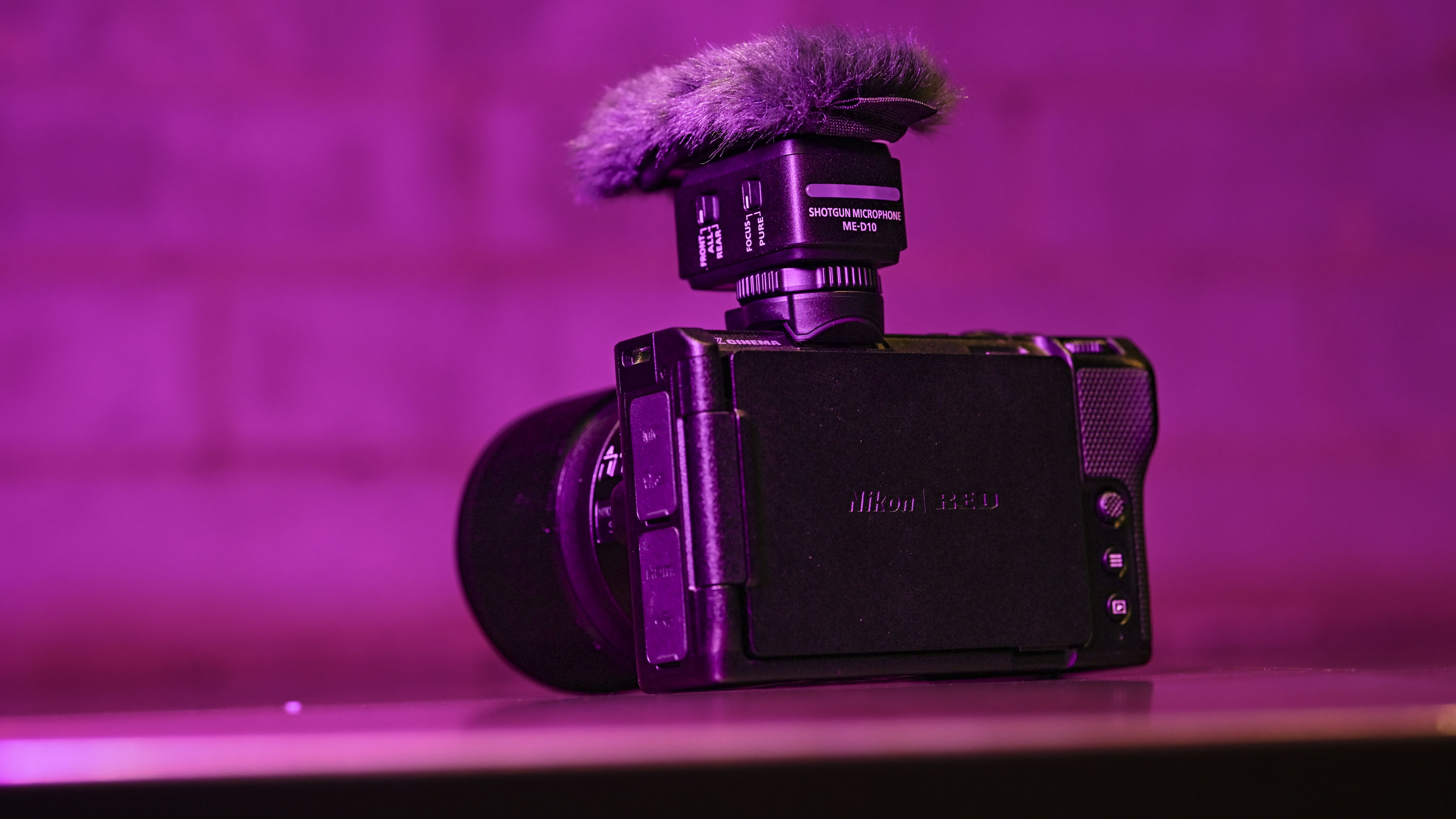 Nikon ZR camera with mic attached, under low key magenta lighting