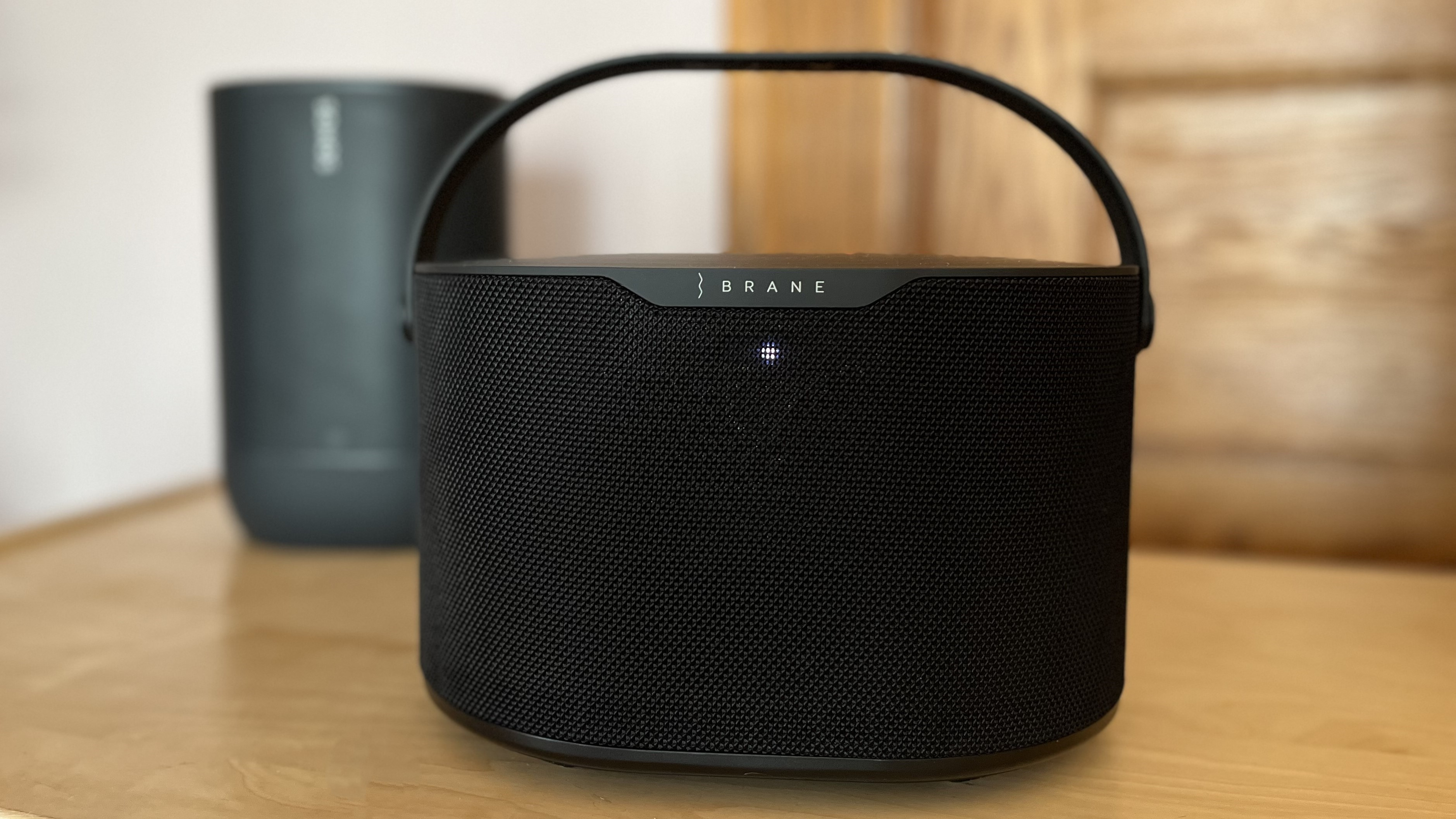 Brane X smart speaker on table with sonos move in background