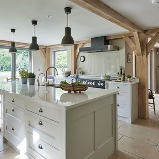 kitchen with white wall wooden beams on wall chimney and white counter