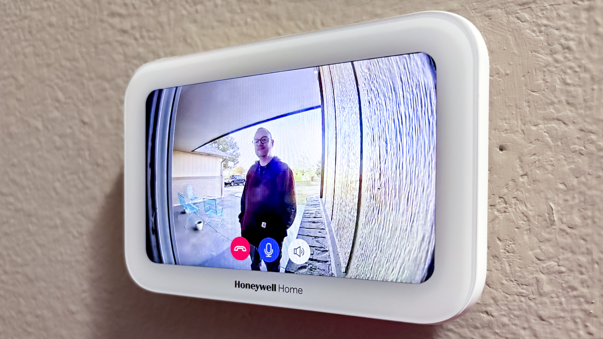 Honeywell Home X8S Smart Thermostat mounted to a hallway wall