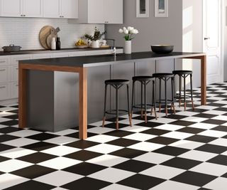 grey and white kitchen with large modern kitchen island and black and white chequerboard flooring