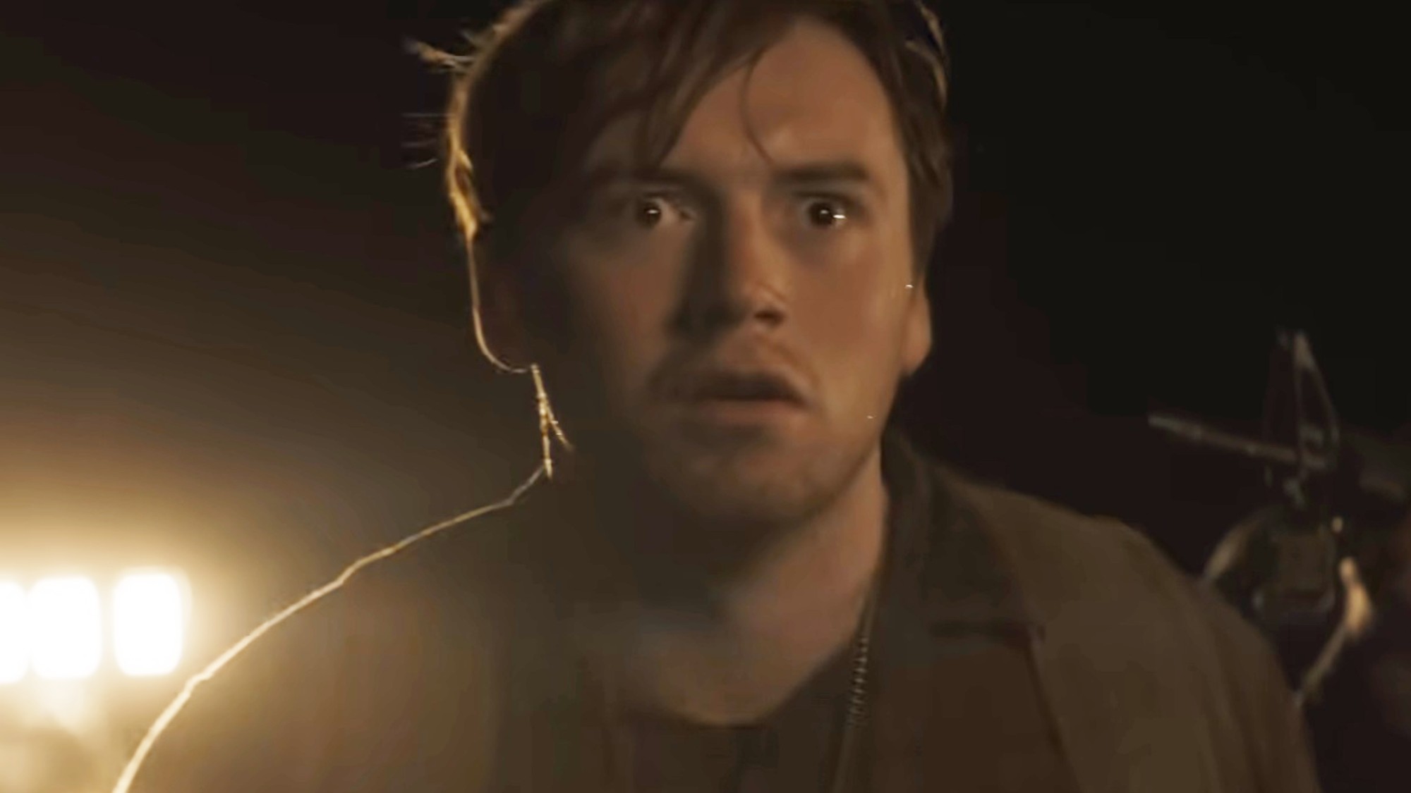 A stunned Cooper Hoffman at nighttime in The Long Walk