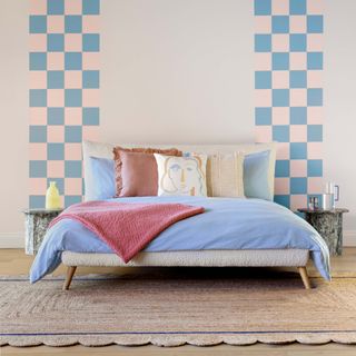 Bedroom with scallop jute rug and pastel coloured bedding