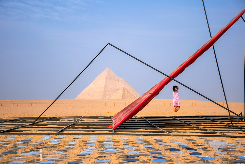 Photograph of a triangular sculpture as it frames the Great Pyramid in Egypt, taken by Abdallah Islam from Egypt, shortlisted in the Youth competition of the Sony World Photography Awards 2026