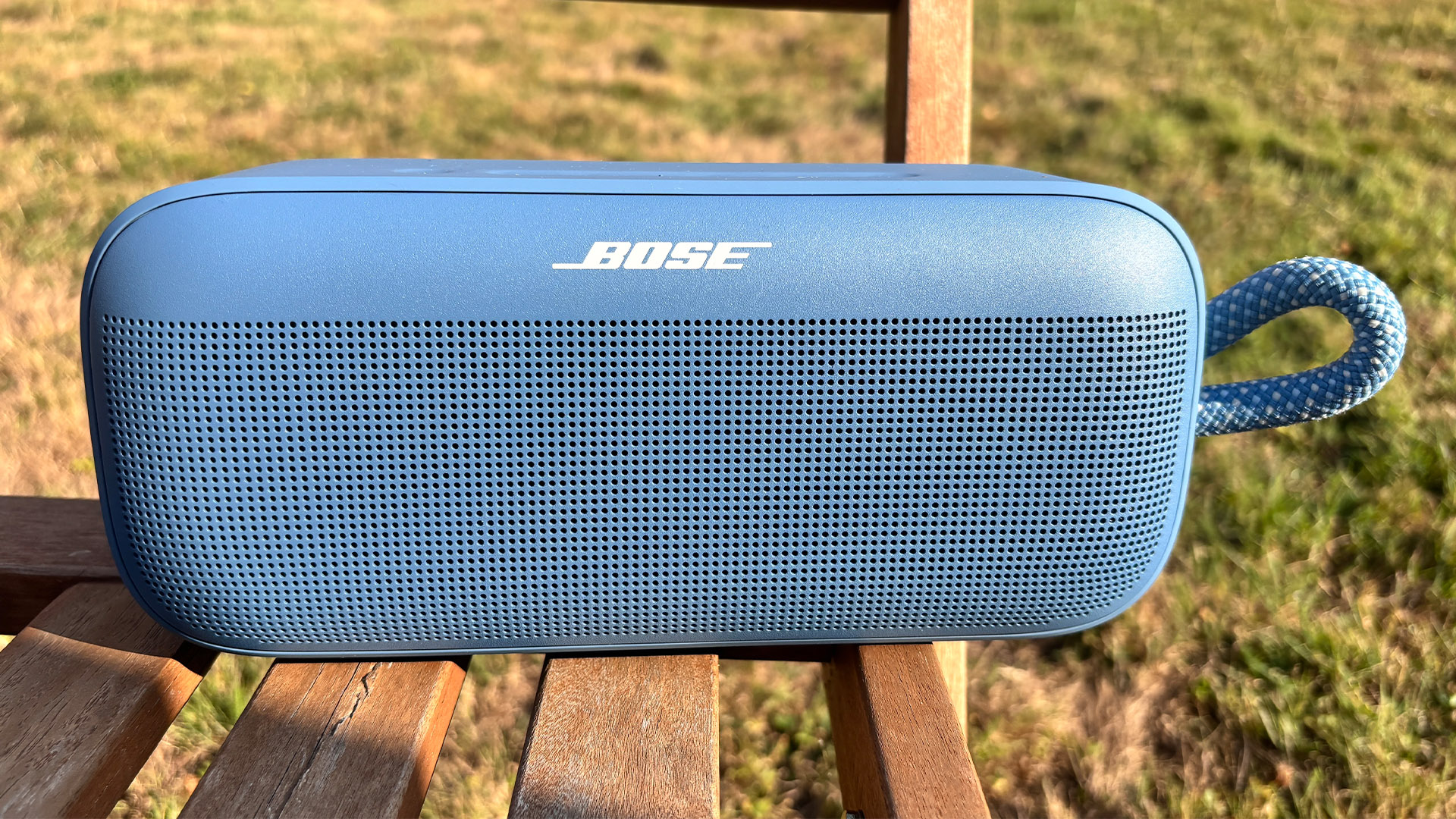 Bose SoundLink Plus wireless speaker on wooden garden chair