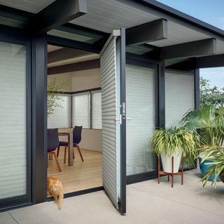 house exterior with doors having roller blinds
