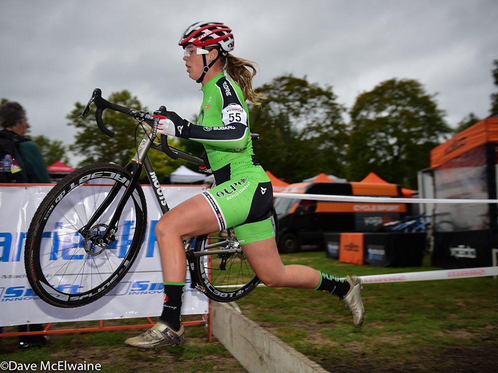 Ashley Zoerner (Alpha Bicycle Company) running one of the sets of barriers on lap four
