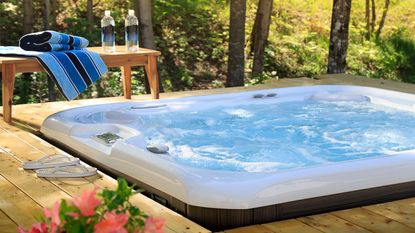 hot tub on a deck overlooking trees