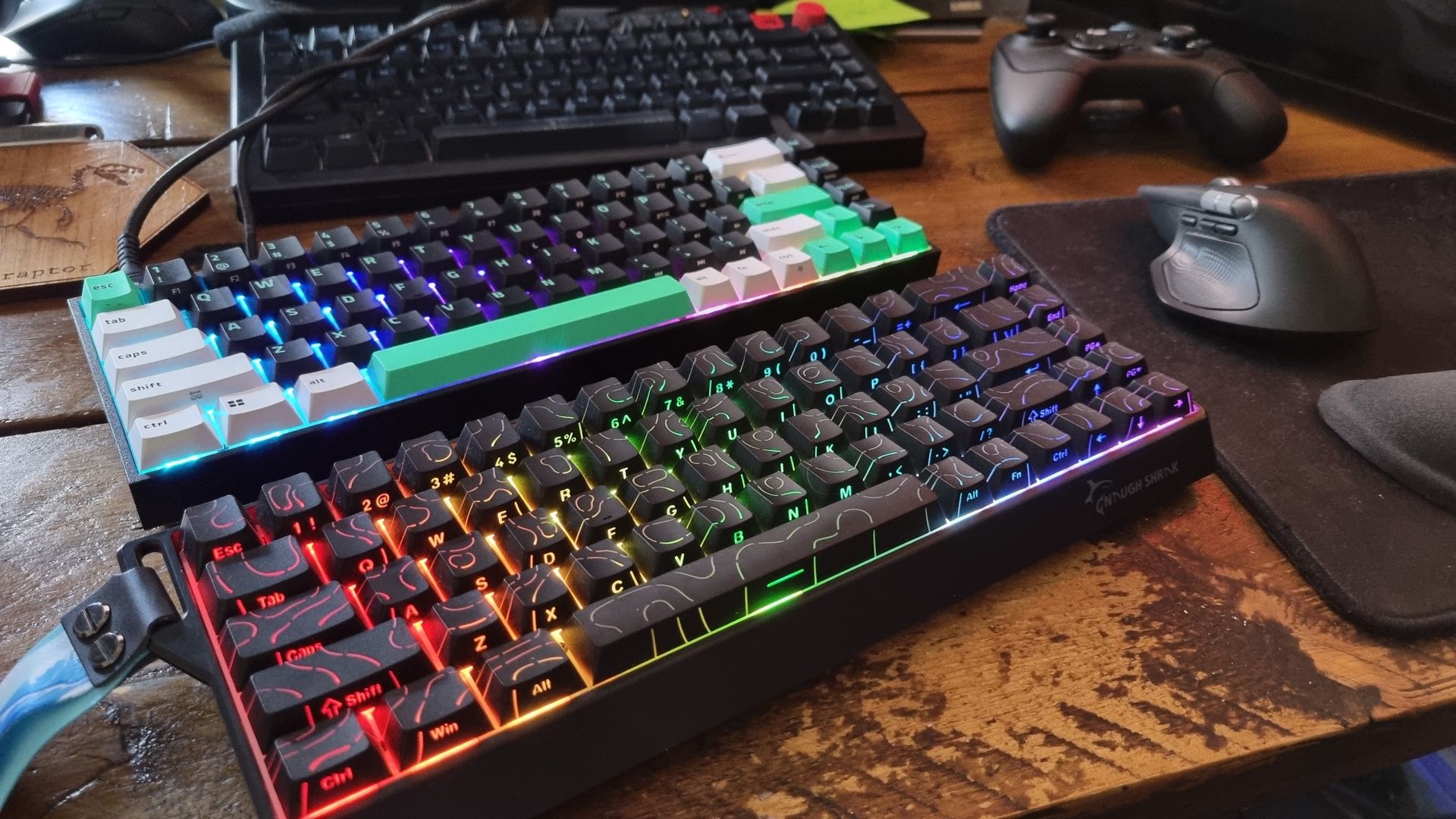 Two budget gaming keyboards on a desk, ready to game