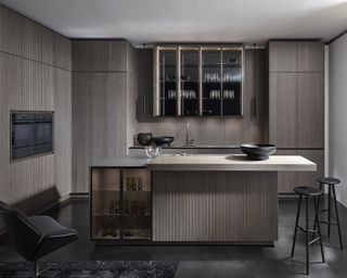 Dark modern kitchen featuring ribbed kitchen island fluting