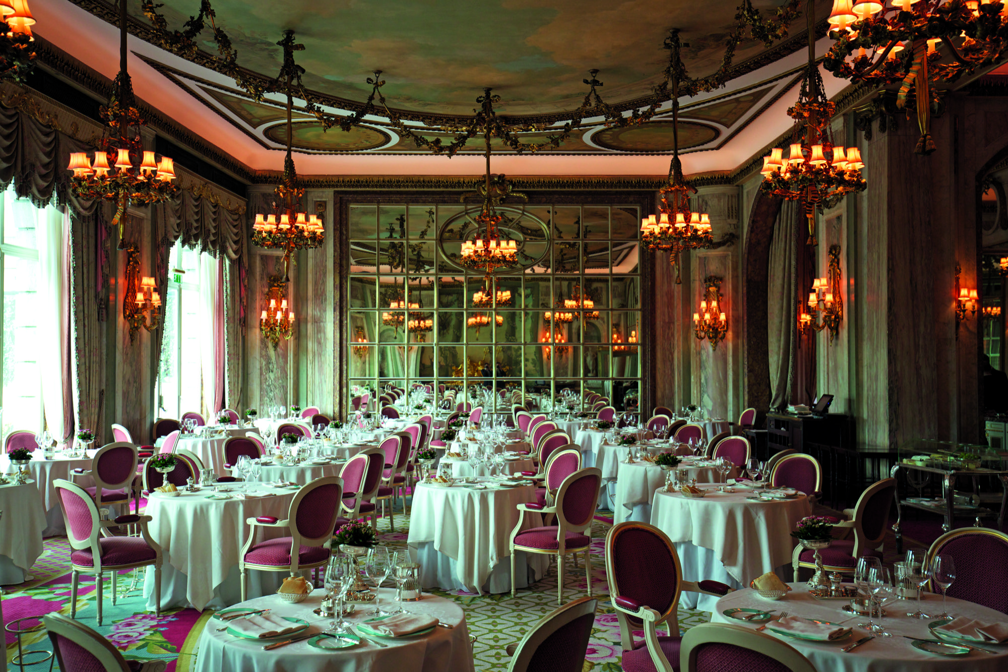 The dining room of the Ritz, with big tables and plenty of mirrors.