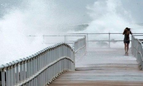 A woman walks along a jetty in Ponce Inlet, Fla., on Oct. 26