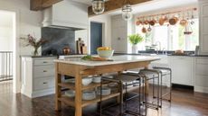 Kitchen with wooden island and marble countertop