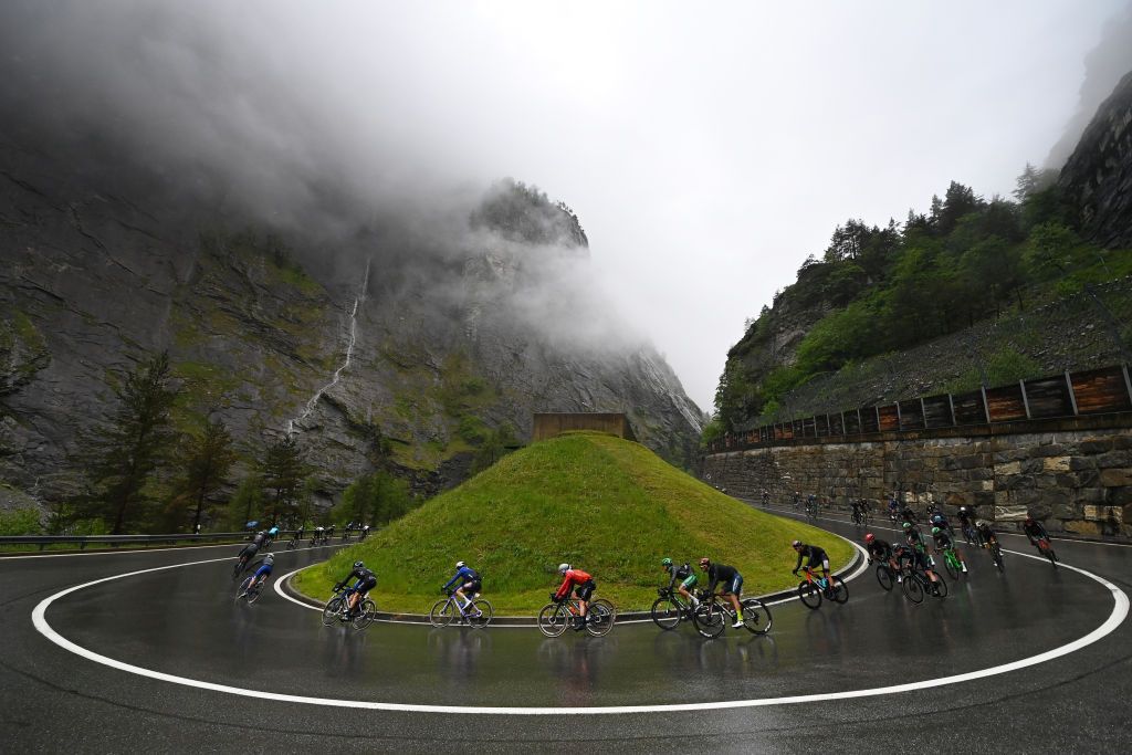 CASSANO MAGNAGO ITALY MAY 20 A general view of the peloton compete racing down the to the Simplon Pass Passo del Sempione 2004m during the 106th Giro dItalia 2023 Stage 14 a 194km stage from Sierre to Cassano Magnago UCIWT on May 20 2023 in Cassano Magnago Italy Photo by Tim de WaeleGetty Images