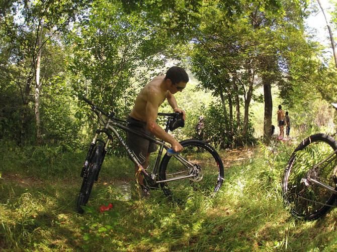 Mike Broderick, Gorilla mechanic, washing bikes by the river at Termas de Conaripe