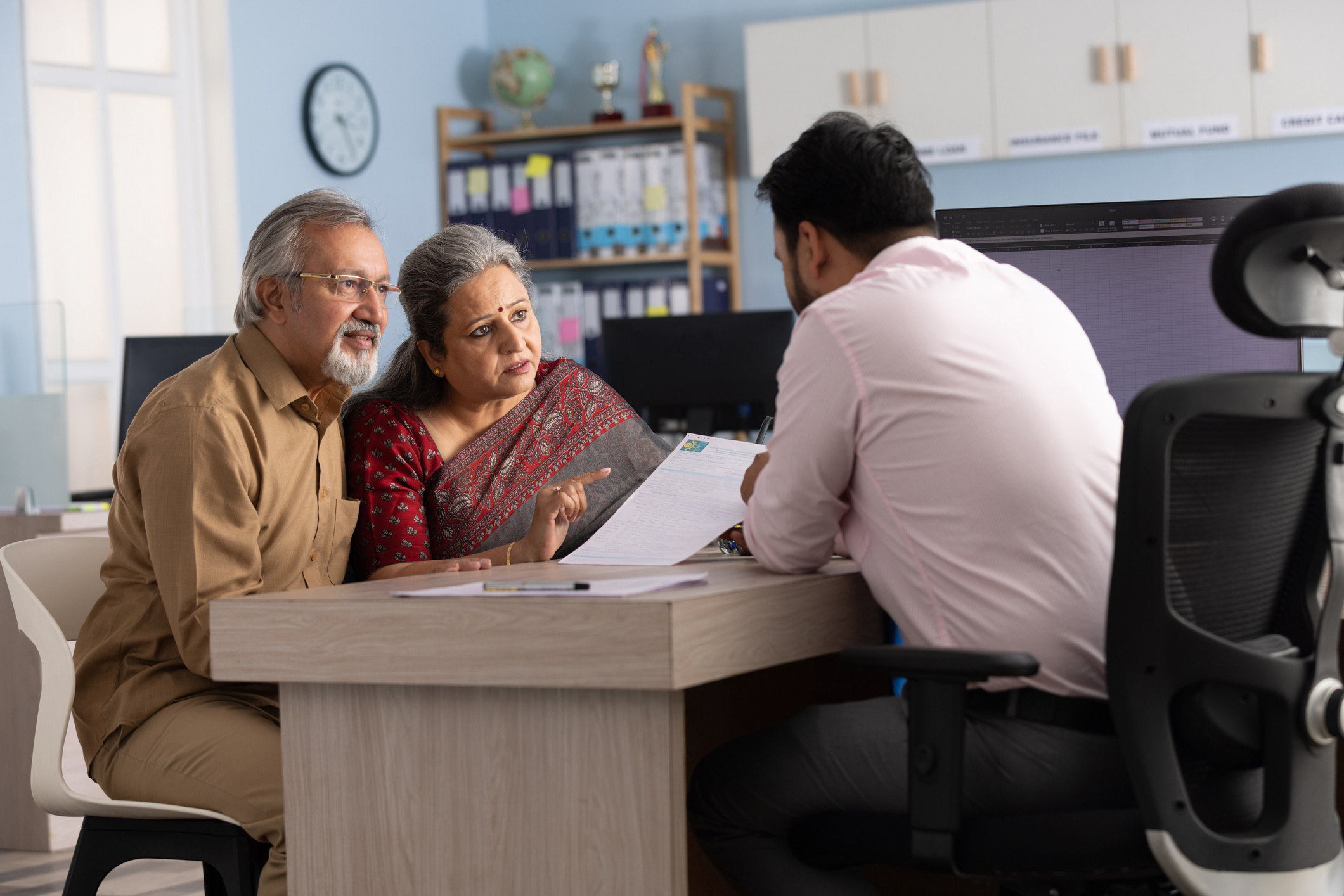 an older couple consulting with a banker