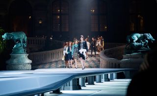 Louis Vuitton: approaching the runway, models walk down an extravagant walkway inside the Louvre
