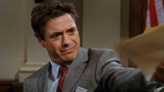 Robert Downey Jr. holds onto some paperwork while looking confused in The Shaggy Dog.