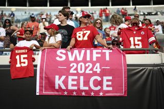 A Kansas City Chiefs fan holds a campaign sign for Taylor Swift and Travis Kelce in the stands before an NFL preseason game against the Jacksonville Jaguars at EverBank Stadium on August 10, 2024 in Jacksonville, Florida.