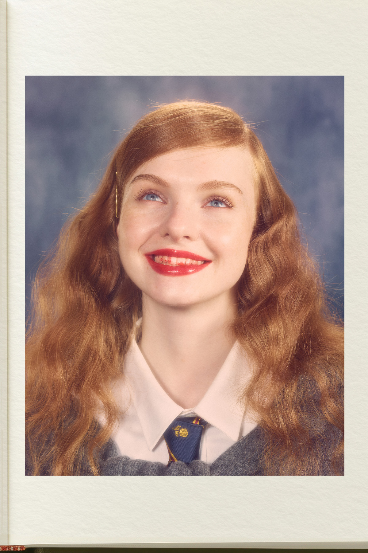 A model with red lipstick on her teeth